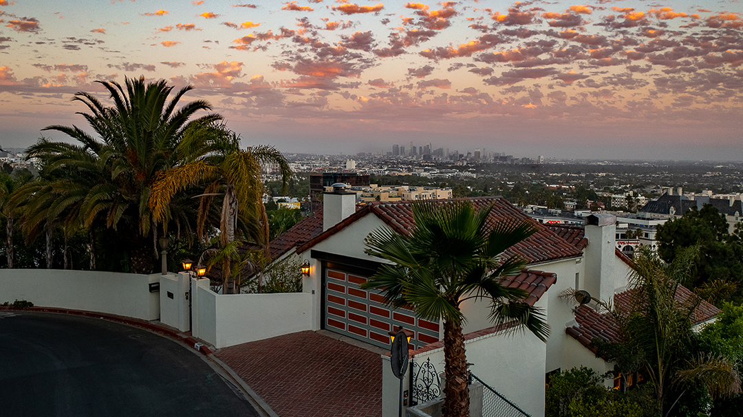 Image of hill side home with city view in the background. Photo by Erik Grammer